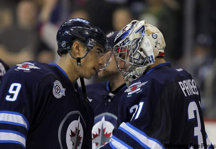 Boris Minkevich / Winnipeg Free Press
Evander Kane taps goalie Ondrej Pavelec's head as he congratulates him for the victory against the Tampa Bay Lightning Monday.