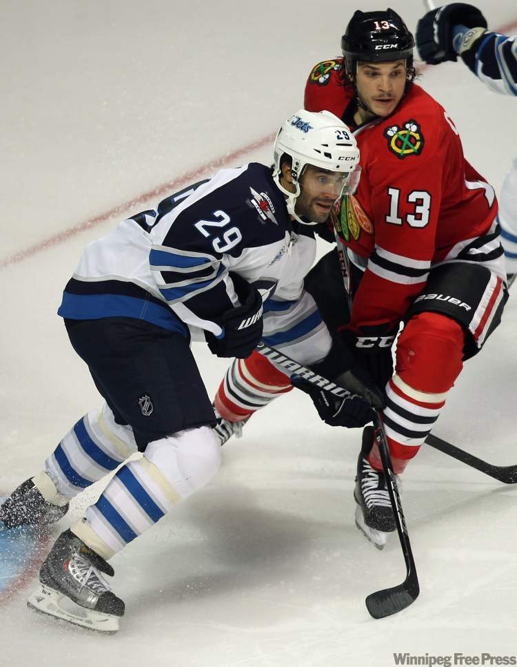 Winnipeg Jets Johhny Oduya, left, parks in front of the net next to Chicago Blackhawks Daniel Carcillo during third period action. (Joe Bryksa / Winnipeg Free Press)