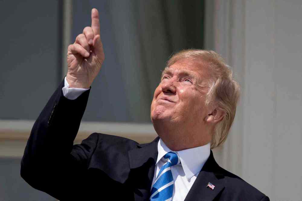 CP
Despite warnings from officials not to look at the sun directly without eye protection, President Donald Trump looks at the sun directly without eye protection ¯_(ツ)_/¯. (AP Photo/Andrew Harnik)