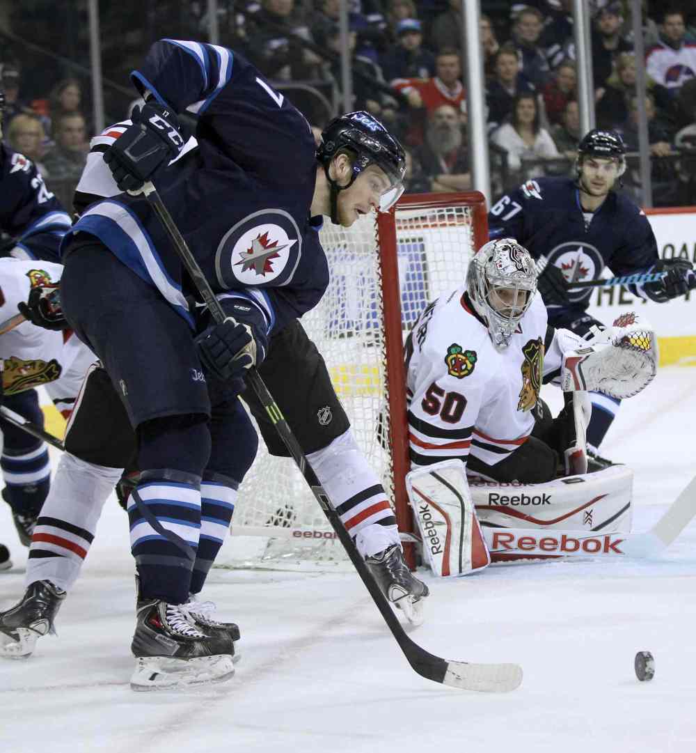 JOE BRYKSA / WINNIPEG FREE PRESS
Winnipeg Jets Adam Lowry lines up a shot at Chicago Blackhawks goaltender Corey Crawford during second period NHL hockey at the MTS Centre in Winnipeg Friday night.