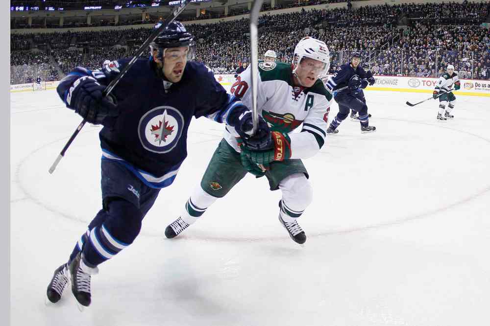 JOHN WOODS / WINNIPEG FREE PRESS
Jets forward Devin Setoguchi and Wild defenceman Ryan Suter drive for the puck in the corner during the second period.