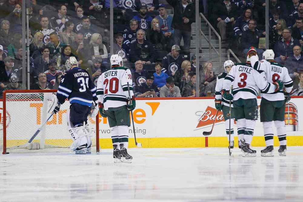 JOHN WOODS / WINNIPEG FREE PRESS
The Minnesota Wild's Ryan Suter (20), Zach Parise (11), Charlie Coyle (3) and Mikko Koivu (8) celebrate Coyle's goal as Winnipeg Jets goaltender Michael Hutchinson fishes the puck out of the net in the second period.