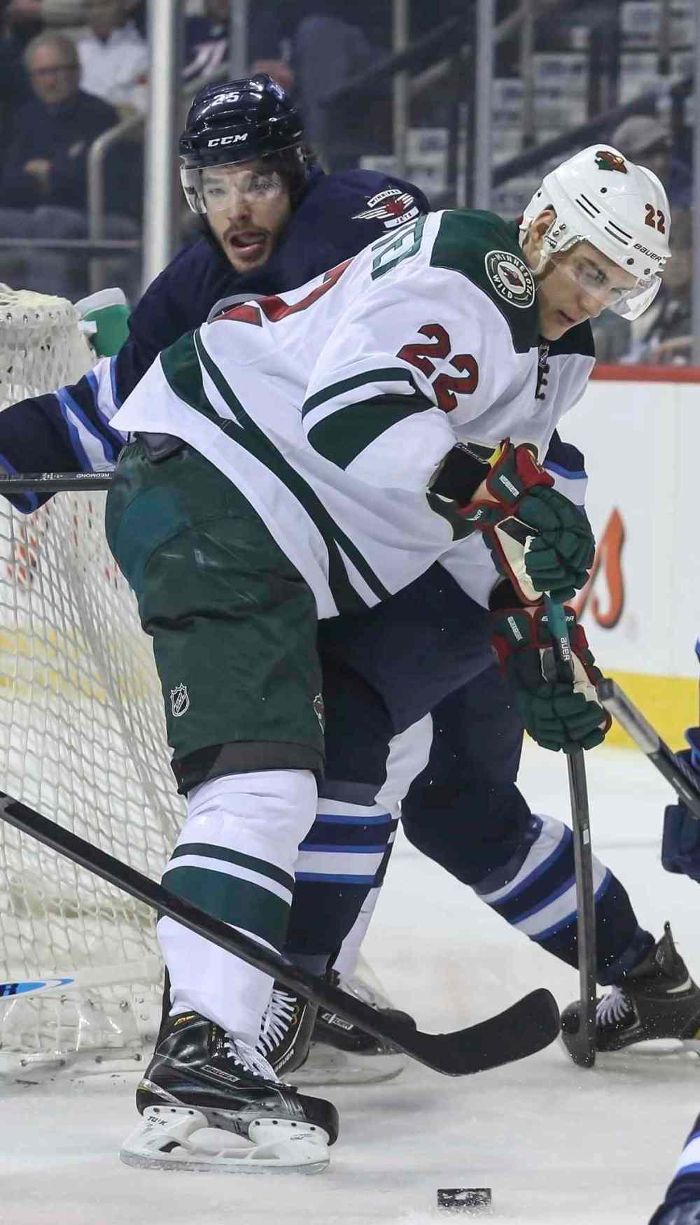 CRYSTAL SCHICK / WINNIPEG FREE PRESS
Jets defenceman Zach Redmond battles for the puck with the Wild's Nino Niederreiter in the Jets' zone during the first period.