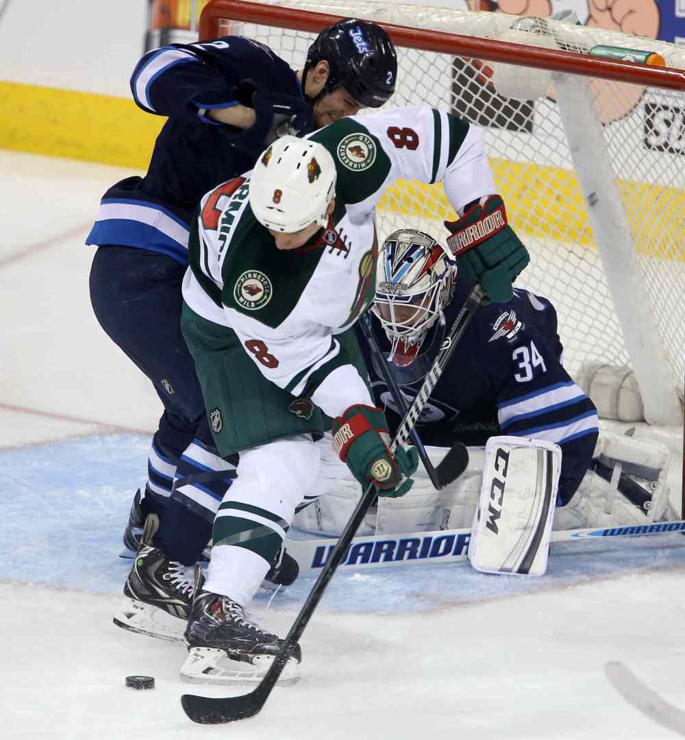 TREVOR HAGAN / THE CANADIAN PRESS
Jets defenceman Adam Pardy battles with the Wild's Cody McCormick in front of Jets goaltender Michael Hutchinson during the first period.