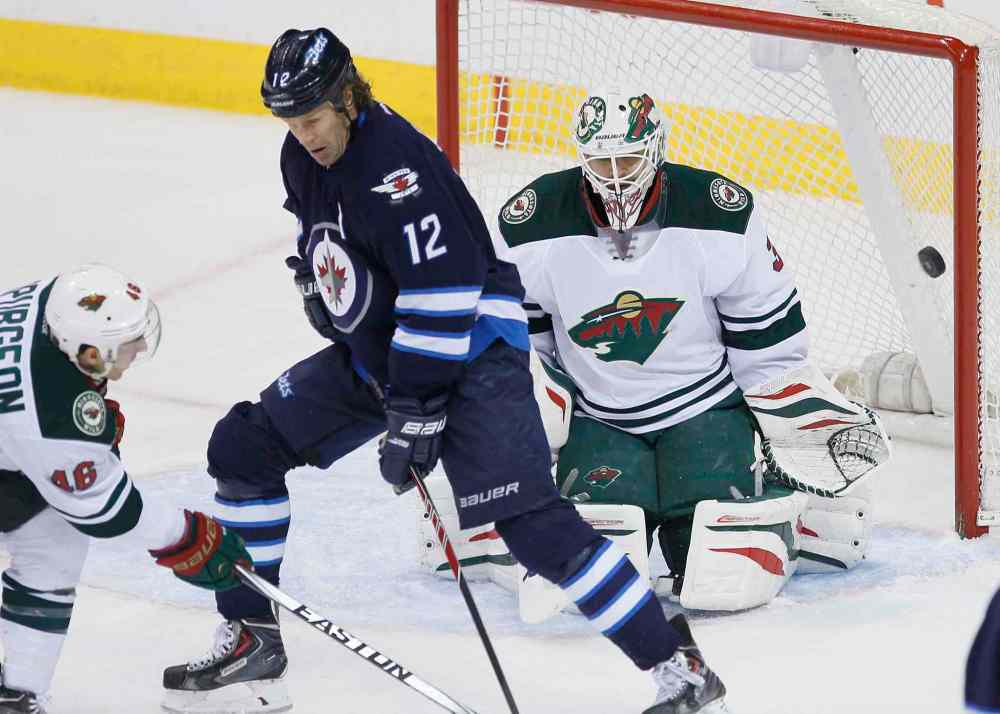 JOHN WOODS / WINNIPEG FREE PRESS
Wild goaltender Ilya Bryzgalov stops a deflection by Jets forward Olli Jokinen as the Wild's Jared Spurgeon defends during the first period.