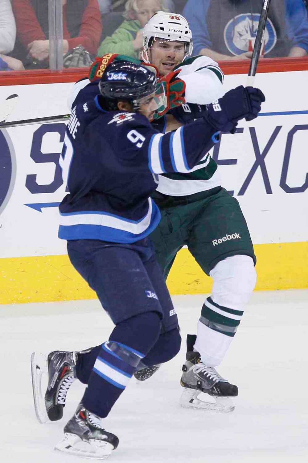 JOHN WOODS / WINNIPEG FREE PRESS
Minnesota's Nate Prosser checks Jets forward Evander Kane as he tries to bust past him during first-period play.