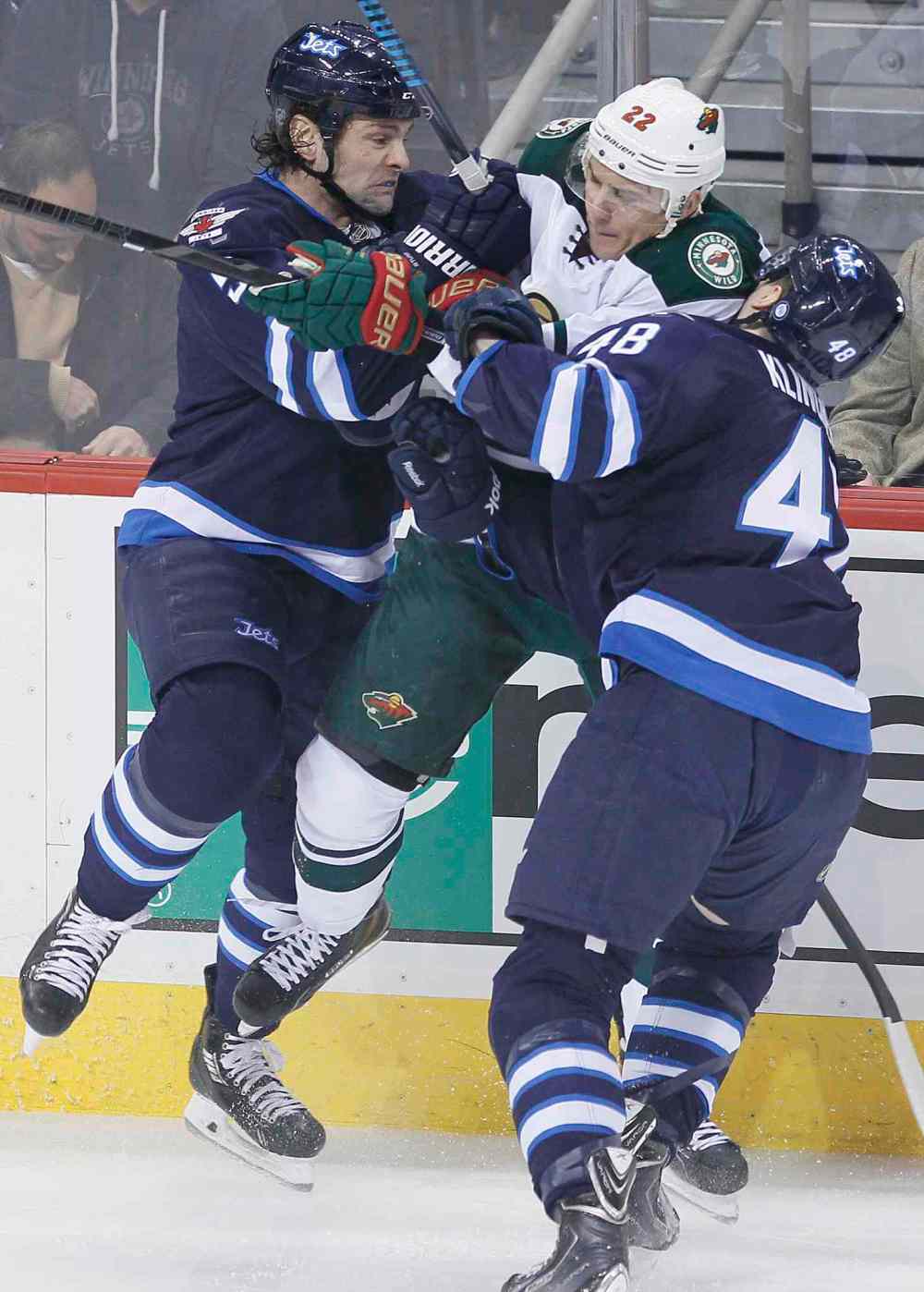 JOHN WOODS / WINNIPEG FREE PRESS
Winnipeg's Mark Stuart (5) and Carl Klingberg (48) sandwich Minnesota's Nino Niederreiter during first-period play.