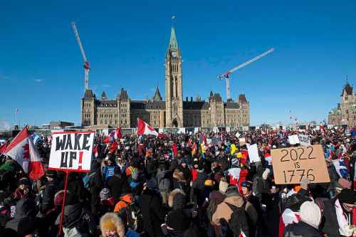 Supporters arrive at Parliament Hill for the Freedom Truck Convoy to protest against COVID-19 vaccine mandates and restrictions in Ottawa, Canada, on Saturday, Jan. 29, 2022. (Lars Hagberg/AFP/Getty Images/TNS)