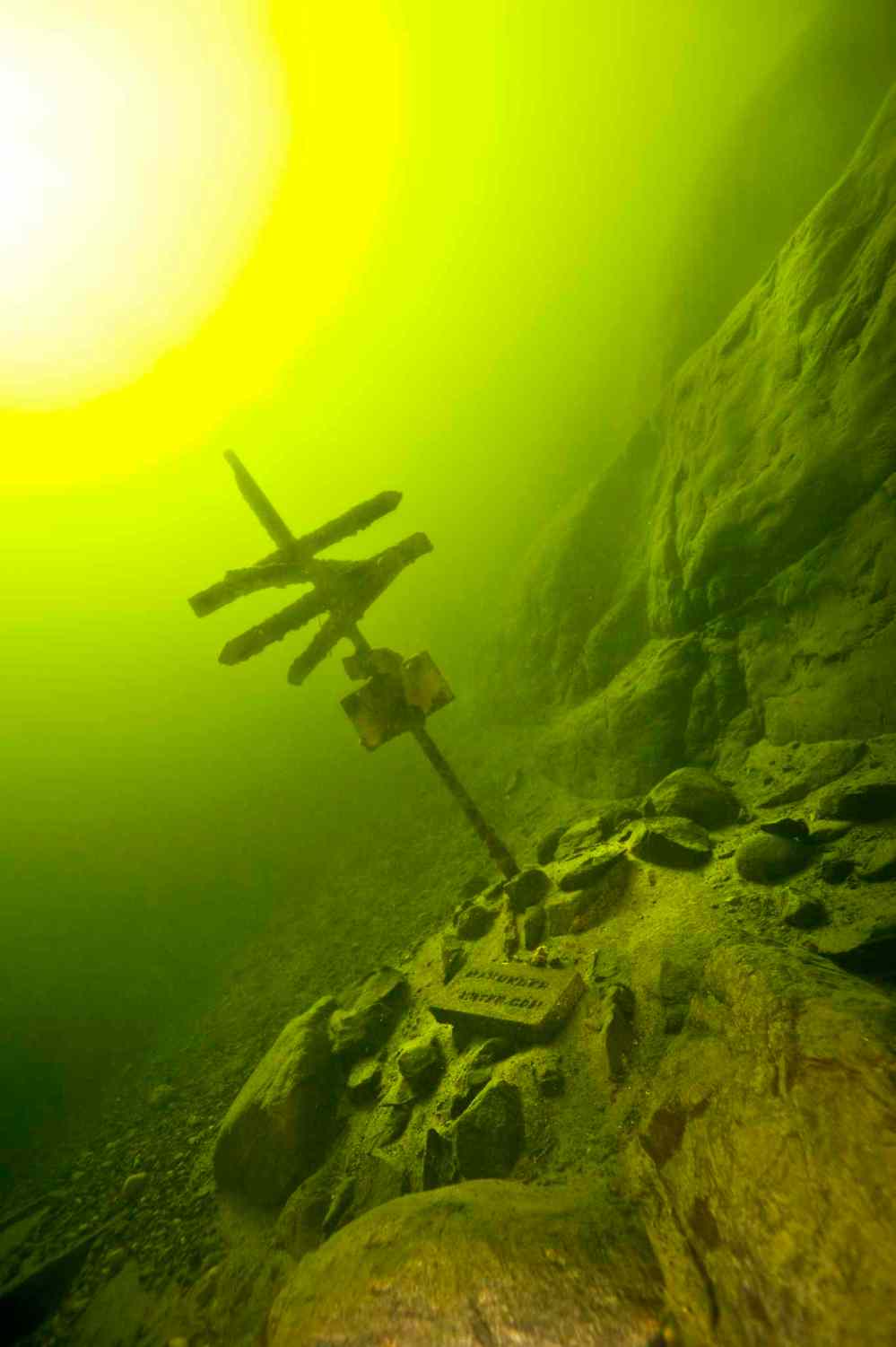 A signpost points the way to various objects on the bottom of West Hawk Lake.