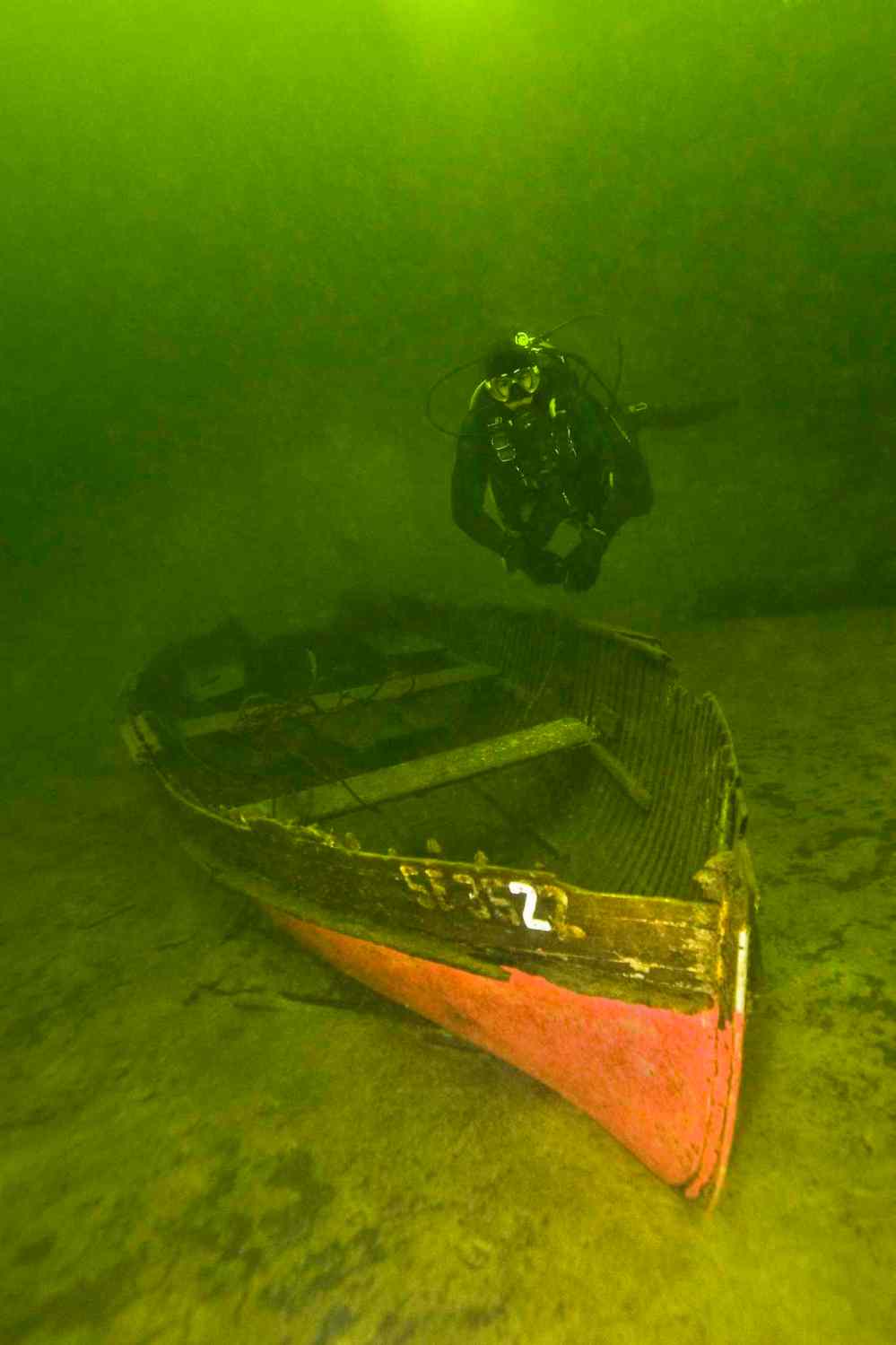 A boat rests on the bottom at a depth of 35 feet (10 metres).