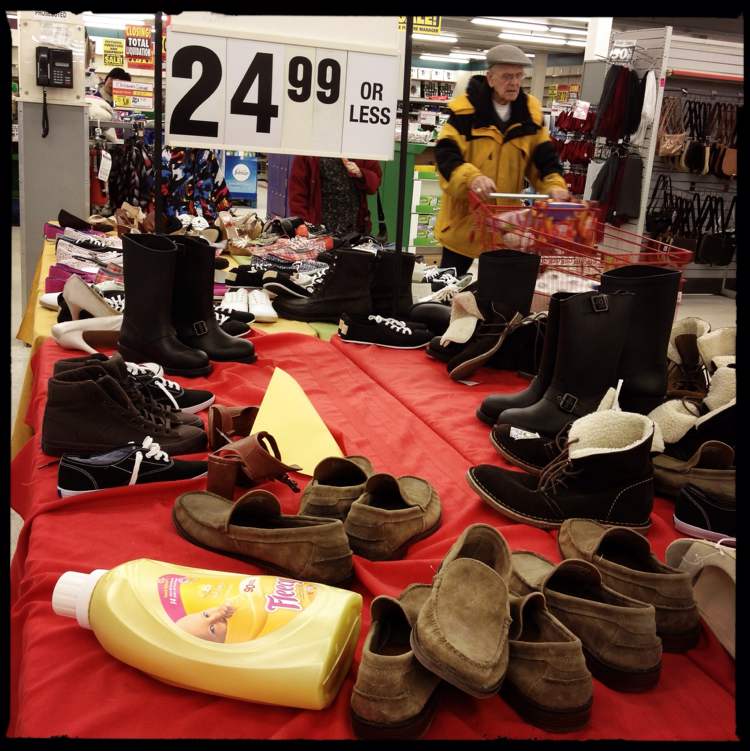 Mike Deal / Winnipeg Free Press
A bottle of fabric softener lays discarded on a table of discounted footwear.