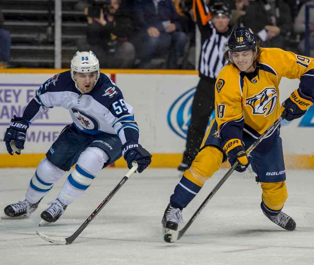 Nick Wagner photo
Predators' centre Calle Jarnkrok fires the puck as Winnipeg's Mark Scheifele closes in during Saturday's game at Bridgestone Arena.