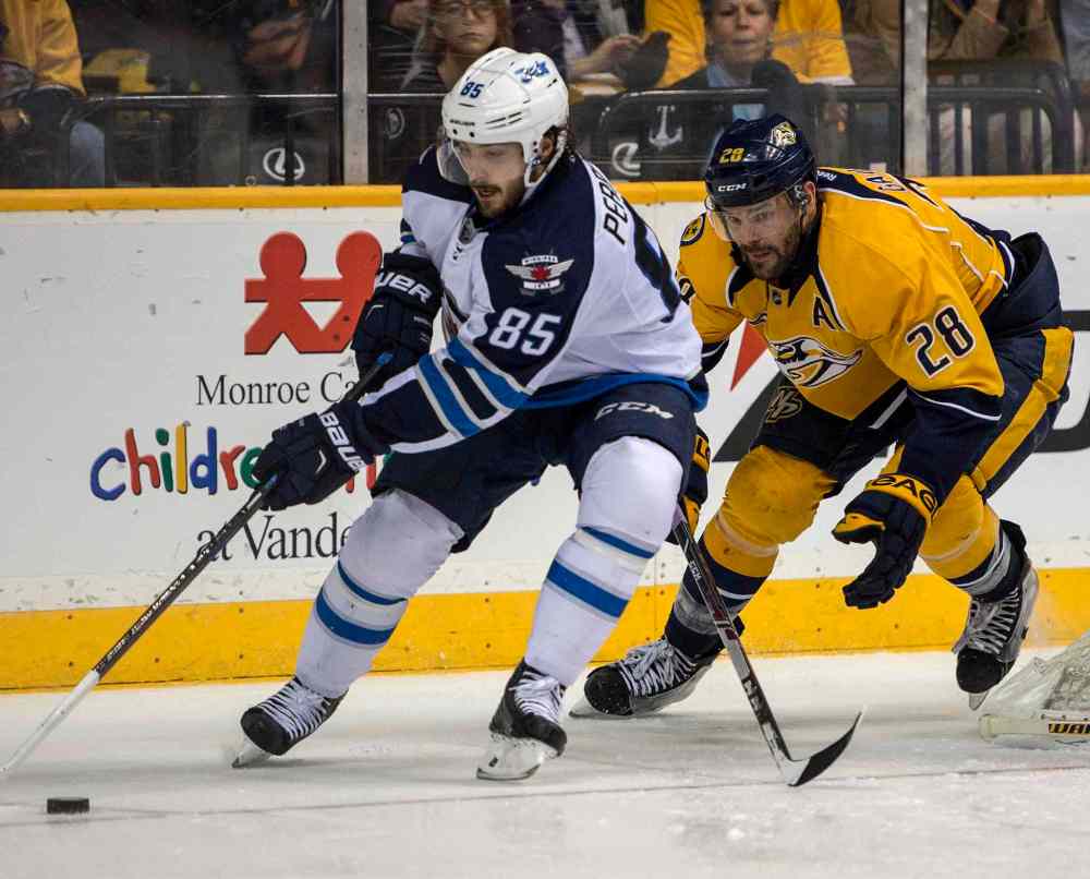 Nick Wagner photo
Nashville centre Paul Gaustad gives chase to Winnipeg's Mathieu Perreault behind the Predators' net.