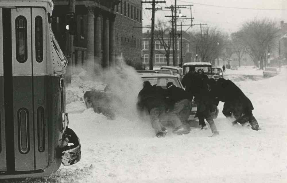 Winnipeggers, sightseers in their own city, marvelled at the enormous piles of snow... then got down to the serious business of digging themselves out. (Gerry Cairns / Winnipeg Free Press Archives)