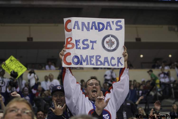 Fans display their pride in regaining an NHL team. (Trevor Hagan / Winnipeg Free Press)