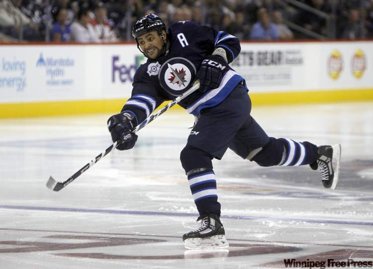 Jet Dustin Byfuglien takes a shot during second-period action. (Trevor Hagan / Winnipeg Free Press)