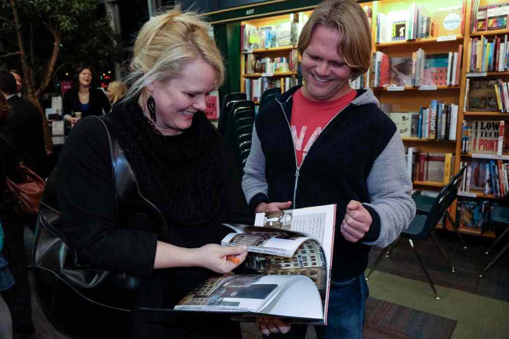 MIKE DEAL / WINNIPEG FREE PRESS
Architect Johanna Hurme (left) and Brent Bellamy (right) look through the book during the launch of the Winnipeg Free Press book City Beautiful at McNally Robinson Thursday evening.