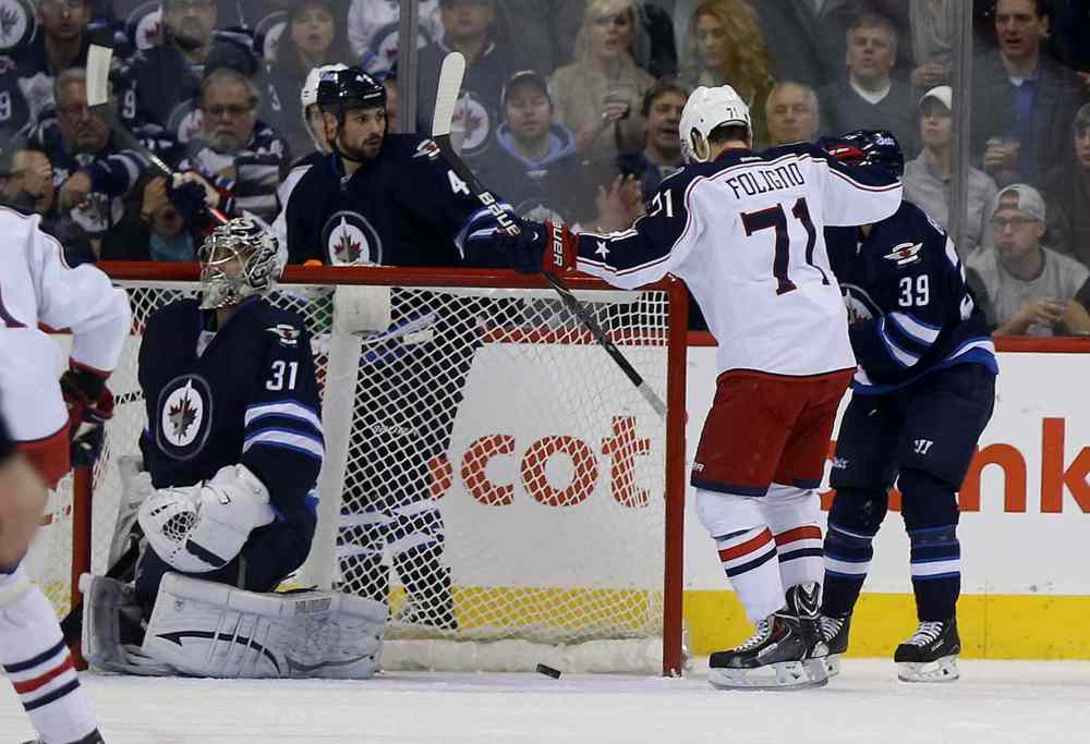 Trevor Hagan / Winnipeg Free Press
Columbus Blue Jackets' Nick Foligno (71) celebrates his second-period goal against the Winnipeg Jets as goaltender Ondrej Pavelec (31), Zach Bogosian (44) and Tobias Enstrom (39) look on.