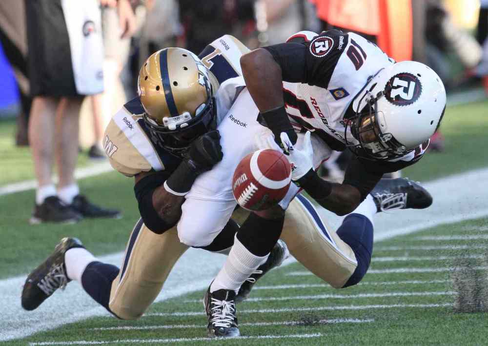 JOE BRYKSA / WINNIPEG FREE PRESS
Winnipeg Blue Bombers' Demond Washington strips the ball from Ottawa Redblacks' Kierre Johnson during the first half of Thursday's game.