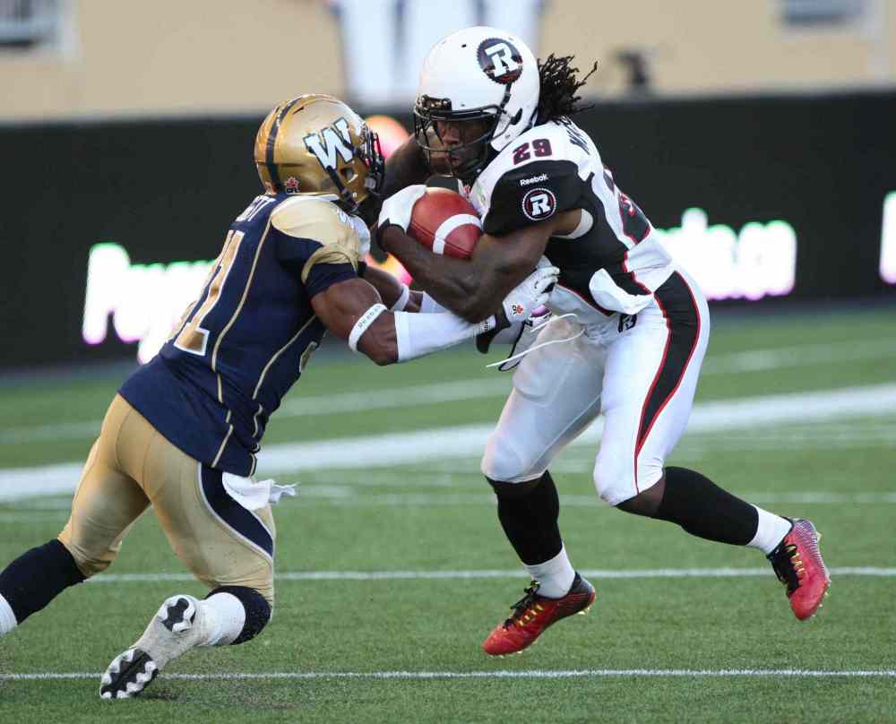 Joe Bryksa / Winnipeg Free Press
Winnipeg Blue Bombers Maurice Leggett ties it up with Ottawa Redblacks Chevon Walker during the first half of Thursday's game at Investors Group Field.