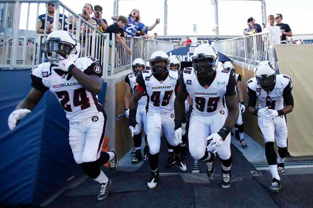 John Woods / The Canadian Press
Ottawa Redblacks hit the field for their CFL game against the Winnipeg Blue Bombers in Winnipeg on Thursday.