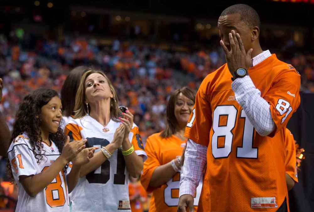 DARRYL DYCK / THE CANADIAN PRESS
Former B.C. Lions' receiver Geroy Simon wipes away a tear as his family applauds during a ceremony where the CFL team retired his number 81 during halftime of the Lions' game against the Winnipeg Blue Bombers in Vancouver, B.C., on Friday.
