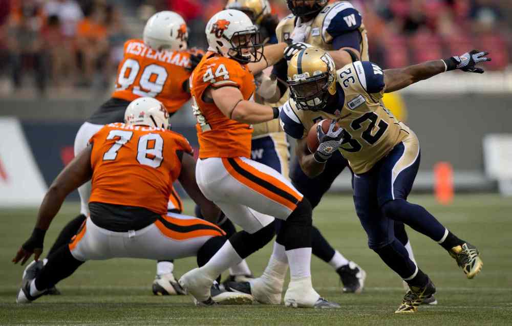 DARRYL DYCK / THE CANADIAN PRESS
Winnipeg Blue Bombers' Nic Grigsby (32) runs the ball past B.C. Lions' Adam Bighill (44) during the first half of Friday's game.