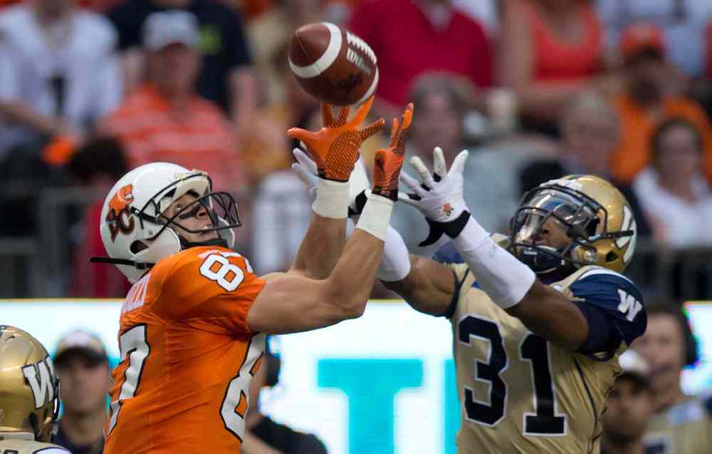 DARRYL DYCK / THE CANADIAN PRESS
B.C. Lions' Marco Iannuzzi, left, reaches but fails to make the reception as Winnipeg Blue Bombers' Maurice Leggett defends during the first half of Friday's game.