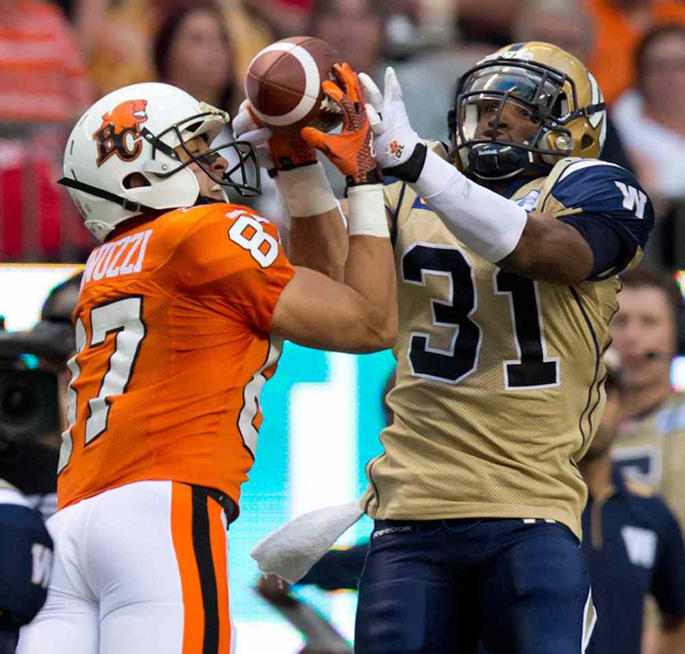 DARRYL DYCK / THE CANADIAN PRESS
Winnipeg Blue Bombers' Maurice Leggett, right, prevents B.C. Lions' Marco Iannuzzi from making the receptionn during the first half of Friday's game.