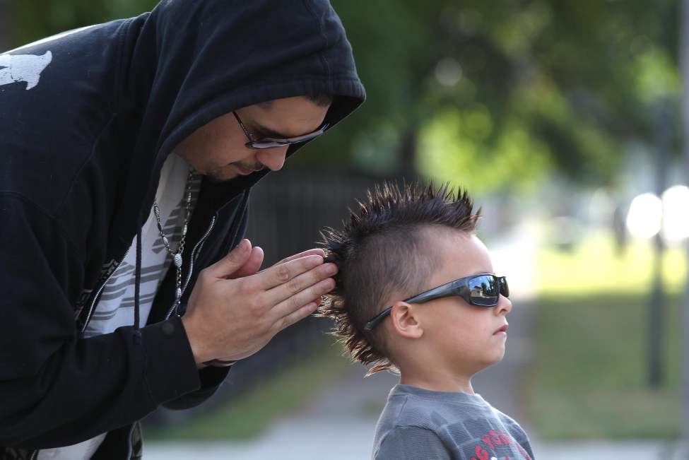 Father Jose Recabarren does some last minute adjustments on his six-year-old son Saint's mohawk before he heads to school. September 11, 2013 (JOE BRYKSA / WINNIPEG FREE PRESS)