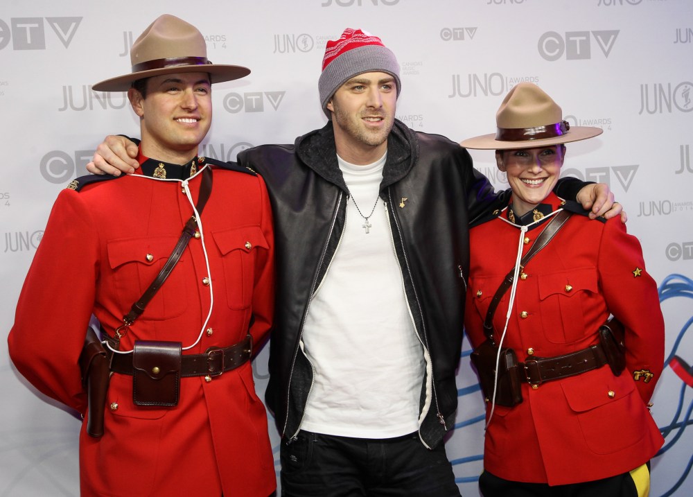 Joe Bryksa/ Winnipeg Free Press
2014 Juno Awards host, and nominee for rap recording of the year and single of the year, Classified gets comfortable with two members of the RCMP on the Juno red carpet at MTS Centre in Winnipeg.
(Joe Bryksa/ Winnipeg Free Press)