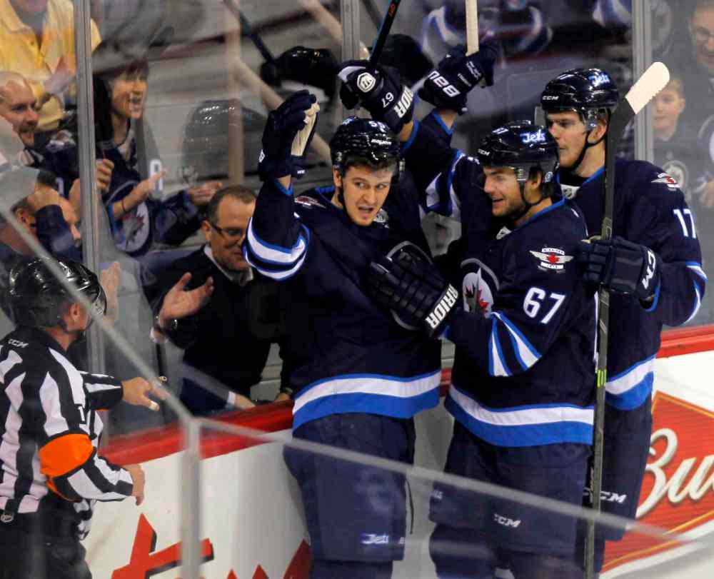 Boris Minkevich / Winnipeg Free Press
Mark Scheifele celebrates with his teammates after scoring his second-period goal.