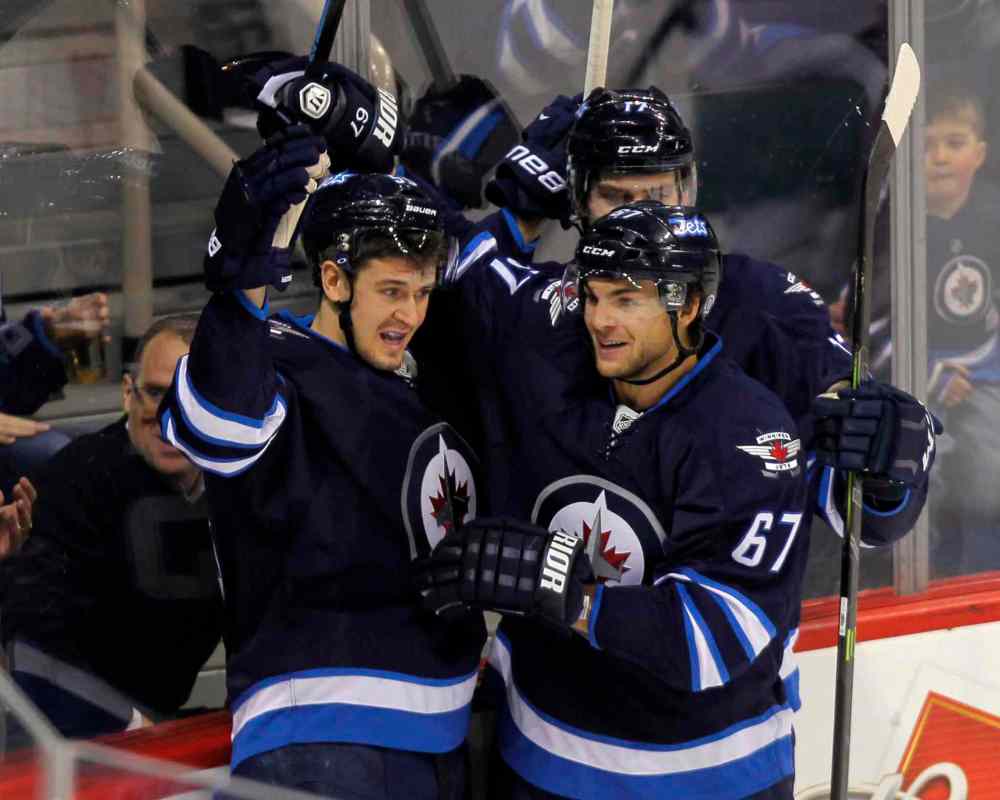Boris Minkevich / Winnipeg Free Press
Mark Scheifele celebrates with his teammates after scoring his second-period goal.