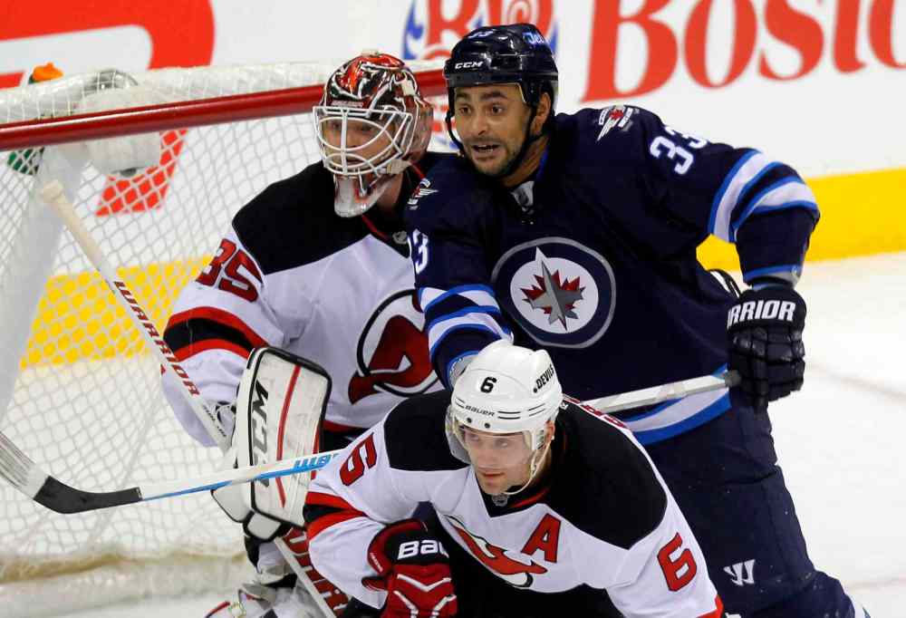 Boris Minkevich / Winnipeg Free Press
The Winnipeg Jets' Dustin Byfuglien battles in front of the Devils' net.