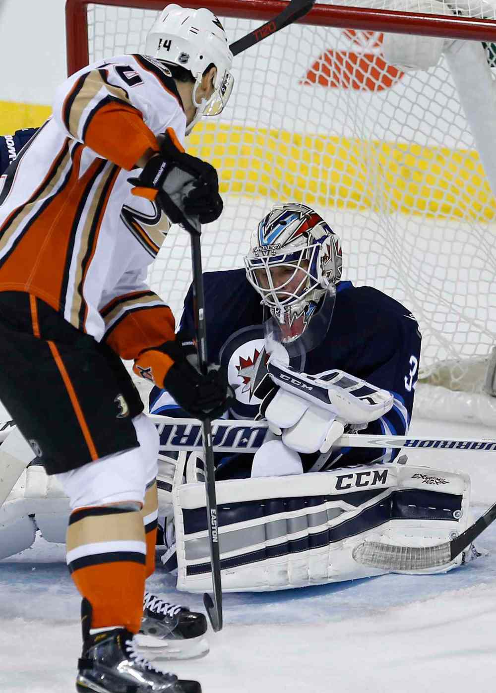 John Woods / The Canadian Press
Winnipeg Jets goaltender Michael Hutchinson (34) hangs onto Anaheim Ducks' Rene Bourque's (14) rebound during the first period.