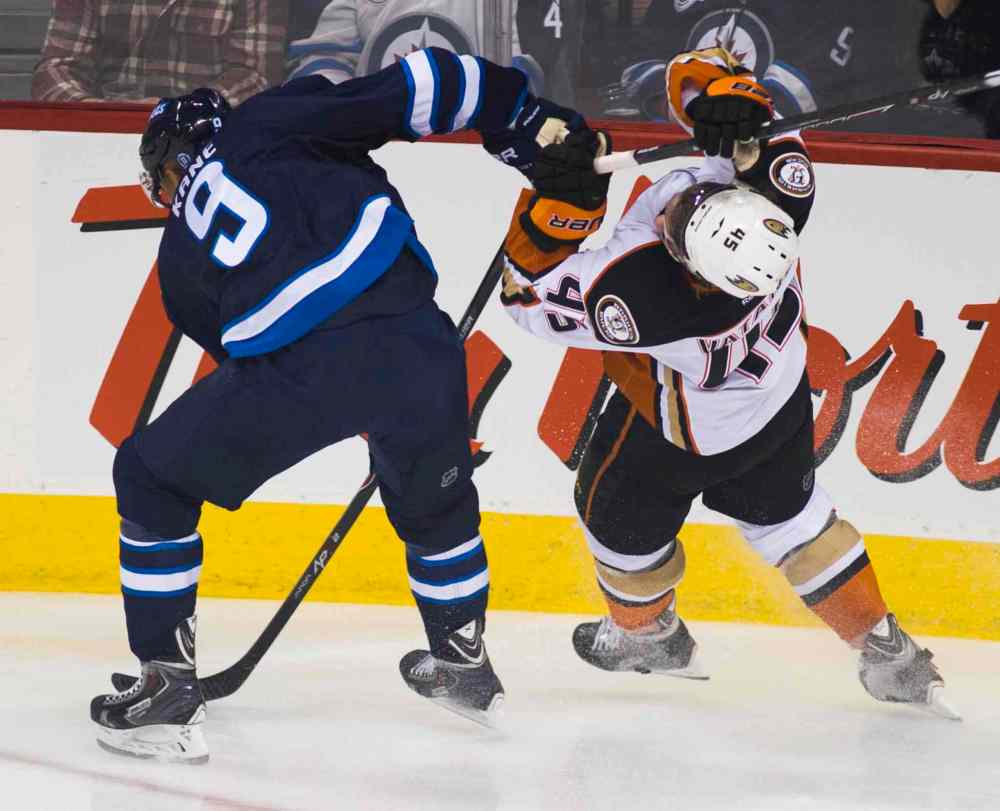 DAVID LIPNOWSKI / WINNIPEG FREE PRESS
Anaheim Ducks Sami Vatanen (#45) and Winnipeg Jets Evander Kane (#9) collide during the first period of Saturday's game.