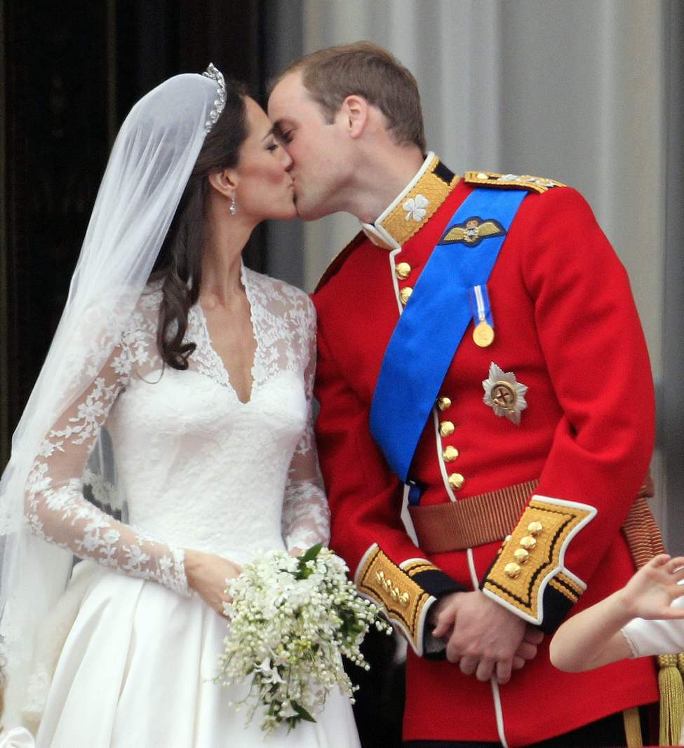 CP
Britain's Prince William kisses his wife Kate, Duchess of Cambridge on the balcony of Buckingham Palace after the Royal Wedding in London Friday, April, 29, 2011. (AP Photo/Matt Dunham)