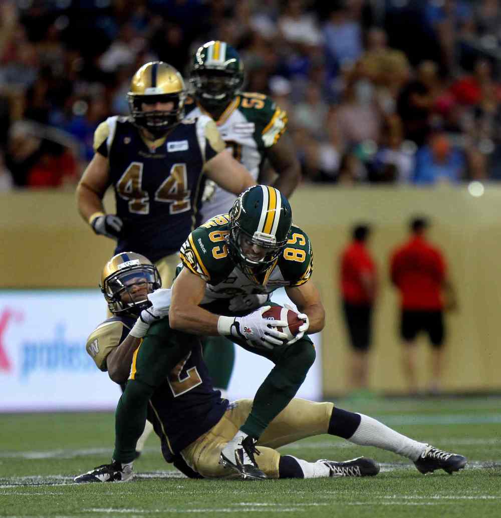 Phil Hossack / Winnipeg Free Press
Winnipeg Blue Bombers' Matt Bucknor hangs on tight to tackle Edmonton Eskimos' #85 Nate Coehoorn in the third quarter Thursday evening at Investors Group Field.