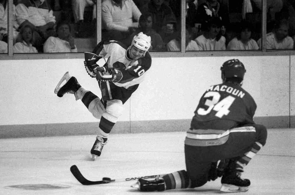 Hawerchuk takes shot past Calgary's Jamie Macoun on April 11, 1987. (Wayne Glowacki / Winnipeg Free Press files)