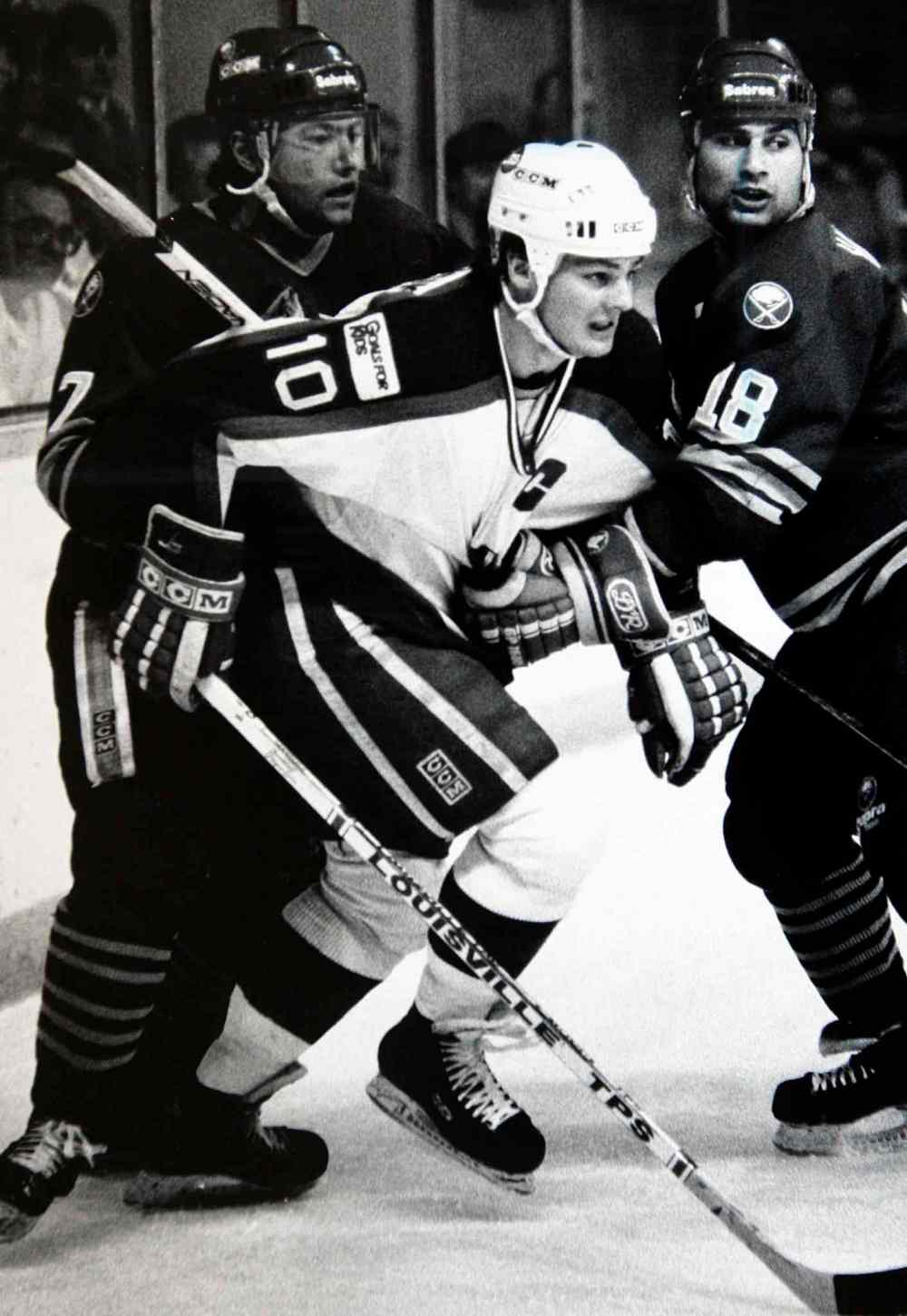 Hawerchuk draws double coverage from Buffalo Sabres John Tucker (7) and Bob Halkidis (18) at the Winnipeg Arena on Feb 12, 1988. (Jeff De Booy / Winnipeg Free Press files)