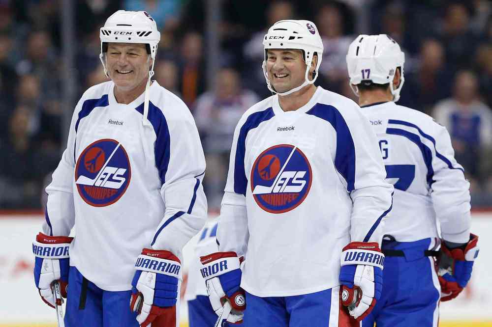 Former Winnipeg Jets Dave Ellett, left, and Dale Hawerchuk take a breather during a practice for the NHL's Heritage Classic Alumni Game. (John Woods / The Canadian Press files)