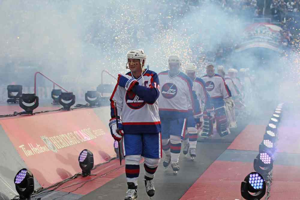 RUTH BONNEVILLE / WINNIPEG FREE PRESS
Dale Hawerchuk, as Jets Alumni Team Captain, leads his team out onto the ice to play against the Edmonton Oilers during the 2016 Tim Hortons NHL Heritage Classic Alumni Game at Investors Group Stadium last October. (Ruth Bonneville / Winnipeg Free Press files)
