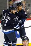 CP
Winnipeg Jets forward Evander Kane (9) and Kyle Wellwood (13) celebrate Kane's goal against the New Jersey Devils during first period NHL action in Winnipeg on Saturday, December 3, 2011. THE CANADIAN PRESS/John Woods
