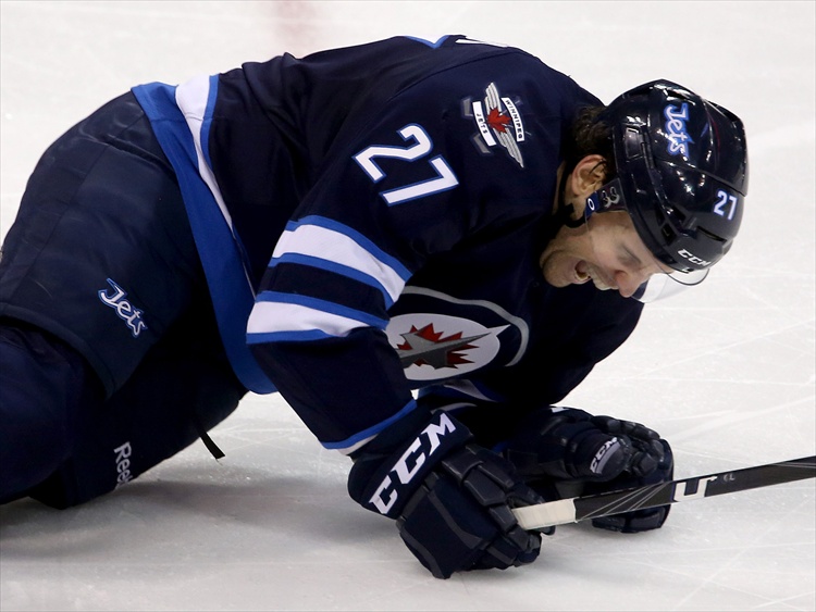 Trevor Hagan / Winnipeg Free Press
Eric Tangradi in pain after making one of four blocks in a single shift during the third period.