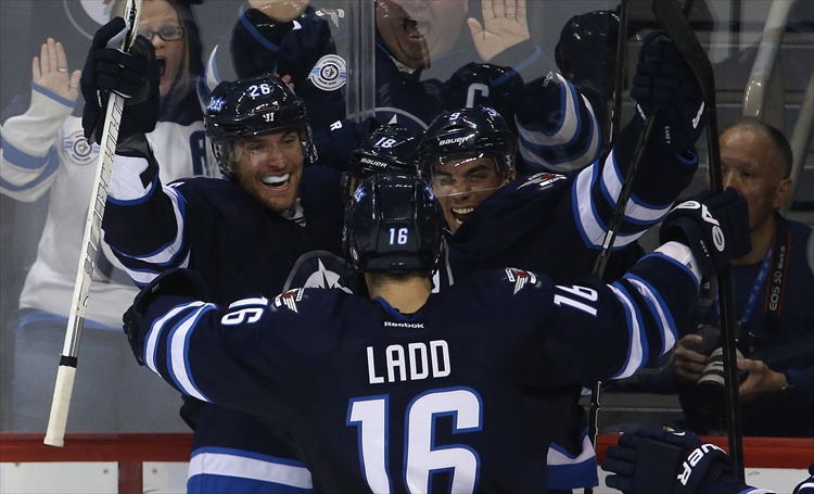 Trevor Hagan / Winnipeg Free Press
Blake Wheeler, Bryan Little, Evander Kane and Andrew Ladd celebrate after Little scored to tie the game late in the third period.