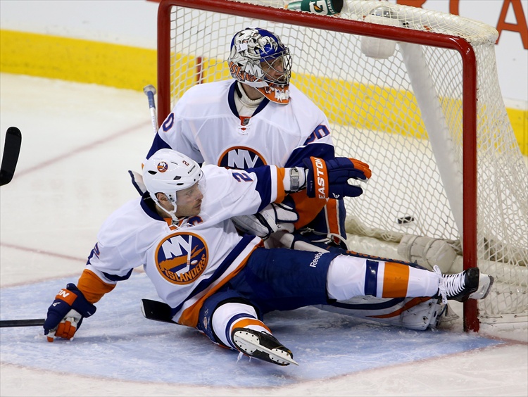 Trevor Hagan / Winnipeg Free Press
Mark Streit falls into goaltender Evgeni Nabokov during the third period.
