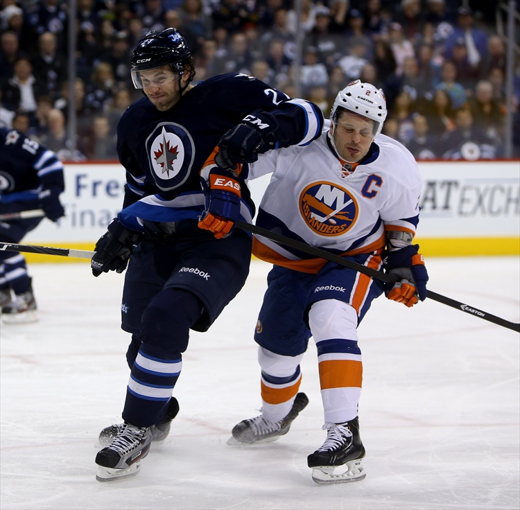 Trevor Hagan / Winnipeg Free Press
Eric Tangradi elbows New York Islanders' Mark Streit as they battle for the puck during the second period.