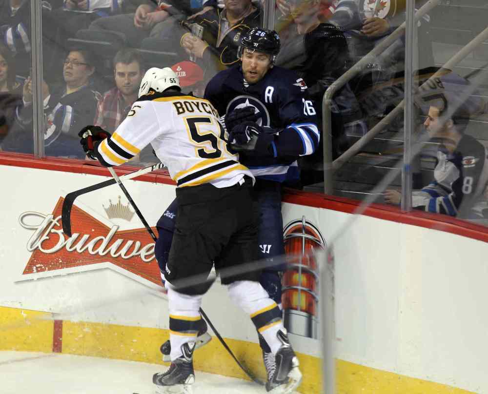 Phil Hossack / Winnipeg Free Press
Bruins' Johnny Boychuk takes out Jets' Blake Wheeler in the first period.