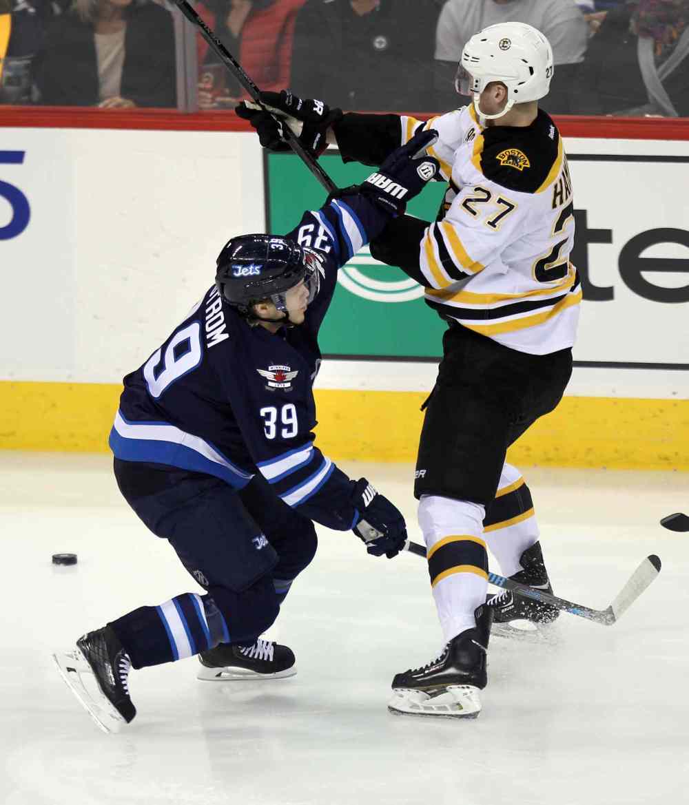 Phil Hossack / Winnipeg Free Press
Jets' Tobias Enstrom ties up the Bruins' Dougie Hamilton during the first period of Thursday's game.