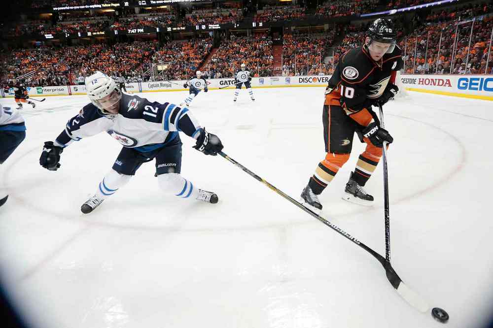 Robert Gauthier / Tribune Media TNS
The Anaheim Ducks' Corey Perry, right, is challenged for the puck by the Winnipeg Jets' Drew Stafford in the first period.